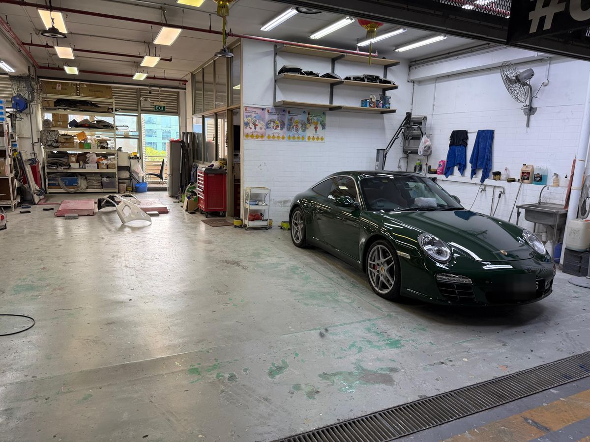 A Porsche 911 in a workshop bay