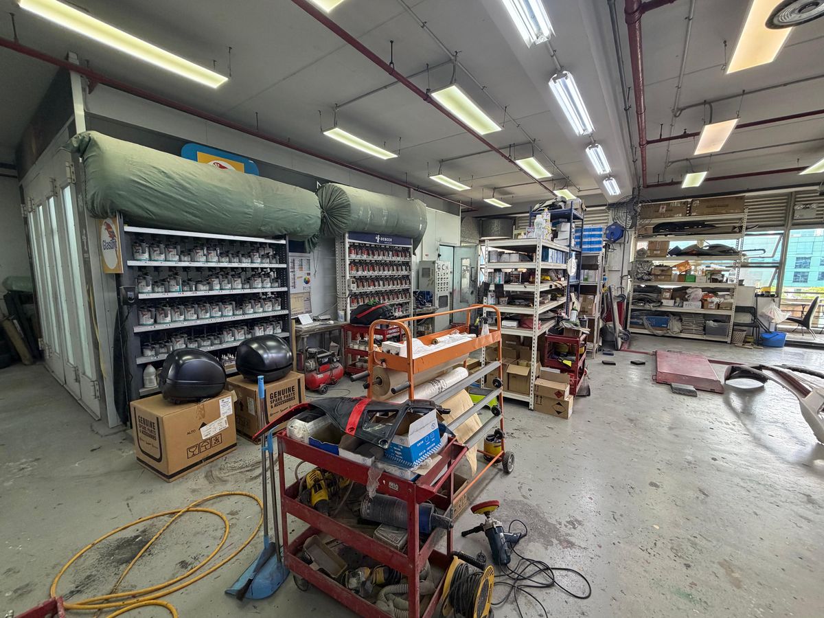 Paint mixing stock on the shelves beside the spray booth